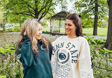 two young women standing with their arm around each other